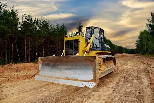 Land grading with heavy equipment